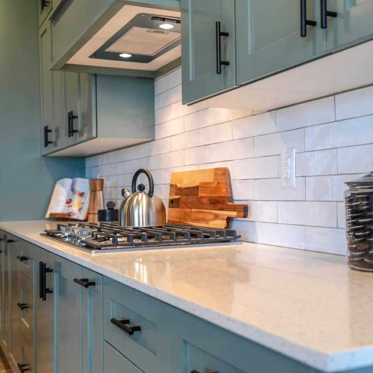 kitchen detail of marble counter with tile backsplash